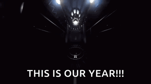 Yellow Car Driving Down Road Saying This Is Our Year