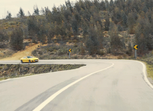 Yellow Car Driving on Road with Trees