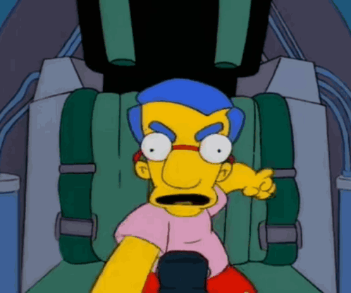 Yellow Cartoon Character With Blue Hair Sitting in Green Seat