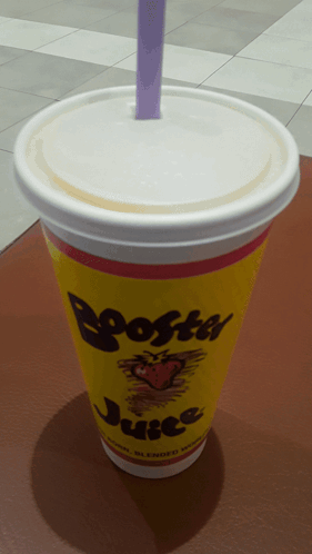 Yellow Cup of Booster Juice With Purple Straw
