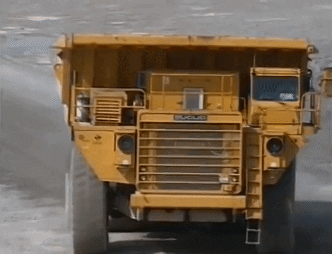 Yellow Dump Truck By Building Saying Matsu GIF