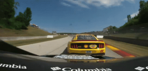 Yellow Race Car Number 22 Driving Down Track
