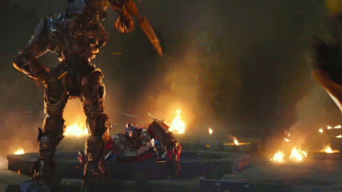 Yellow Robot Fighting Black Robot in Flames