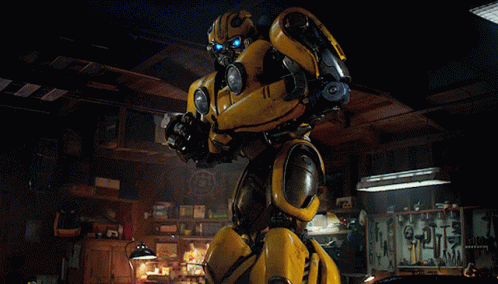 Yellow Robot Standing in Dark Room With Tools