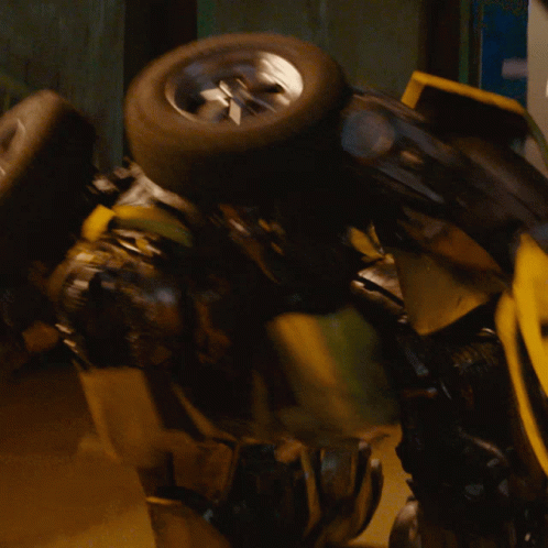 Yellow Robot With Blue Eyes Holding Tire