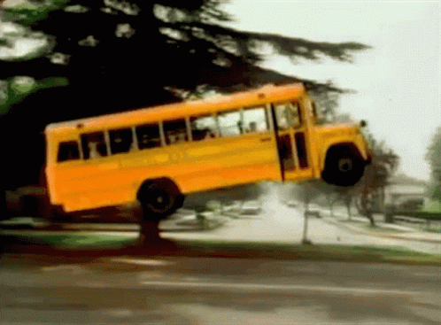 Yellow School Bus Flying Through Air GIF