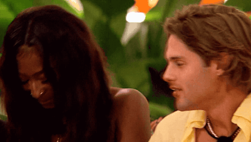 Yellow Shirt Man Talking To Black Top Woman GIF
