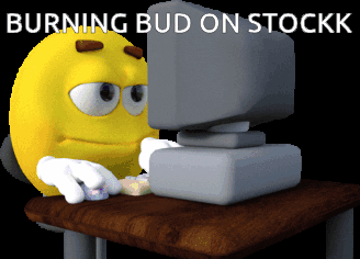 Yellow Smiley Sitting At Computer Burning Bud On Stockk GIF