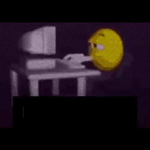 Yellow Smiley Sitting at Desk with Computer