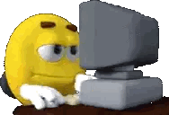 Yellow Smiley Sitting in Front of Computer