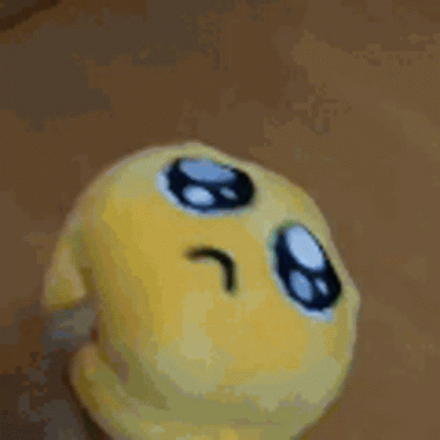 Yellow Stuffed Animal On Green Blanket GIF