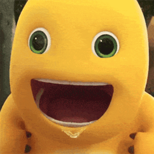 Yellow Stuffed Animal With Green Eyes Smiling With Mouth Open GIF