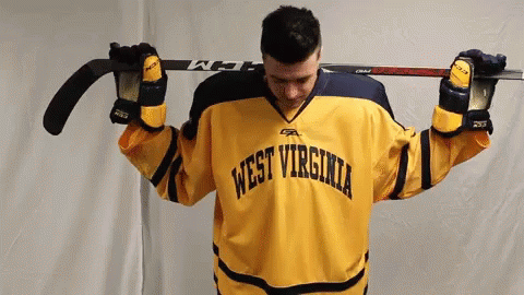 Yellow WV Jersey Man Holding Hockey Stick Overhead
