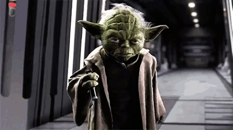 Yoda from Star Wars Holding Lightsaber