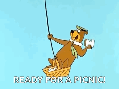 Yogi Bear Flying in Hot Air Balloon Holding Paper