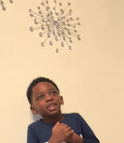 Young Boy At Table With Hands Together GIF