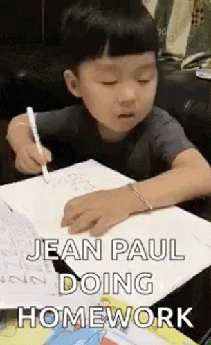 Young Boy Doing Homework With Pen