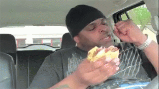 Young Boy Driving Toy Car Down Street GIF