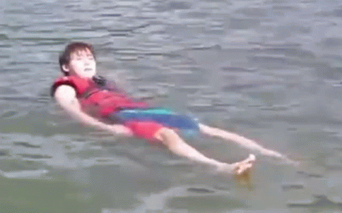 Young Boy Floating On Back In Water GIF