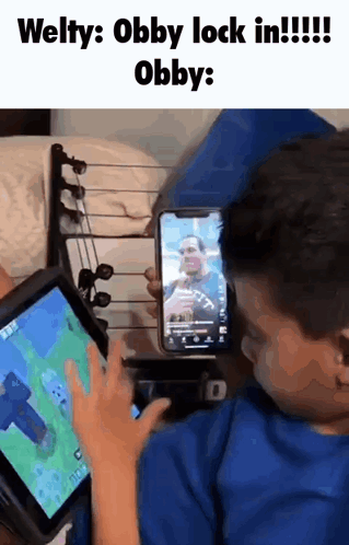 Young Boy Gaming on Tablet Holding Phone