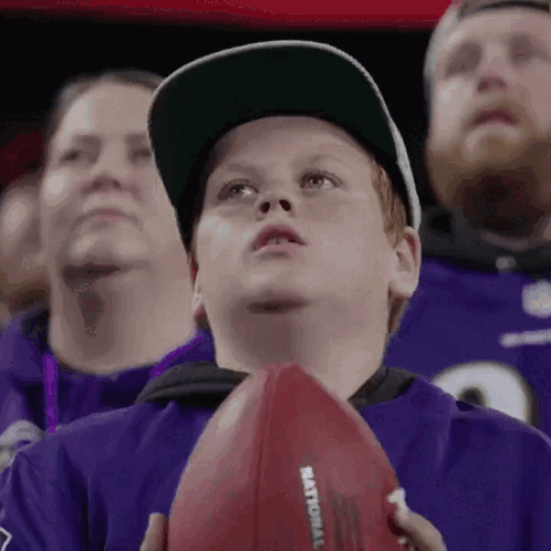 Young Boy Holding Football Saying National