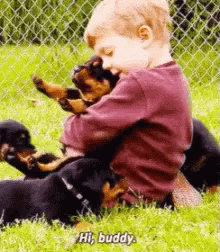 Young Boy Holding Puppy on Grass