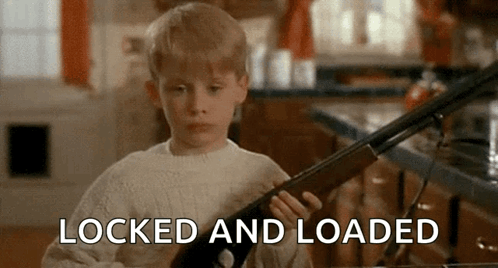 Young Boy Holding Shotgun Saying Locked and Loaded