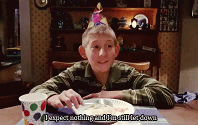 Young Boy In Birthday Hat At Table With Food GIF