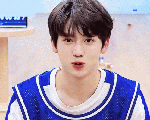 Young Boy in Blue and White Jersey Saying Sea