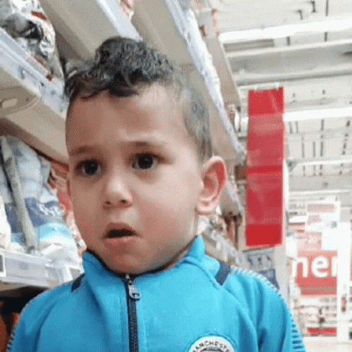 Young Boy in Blue Jacket With Manchester