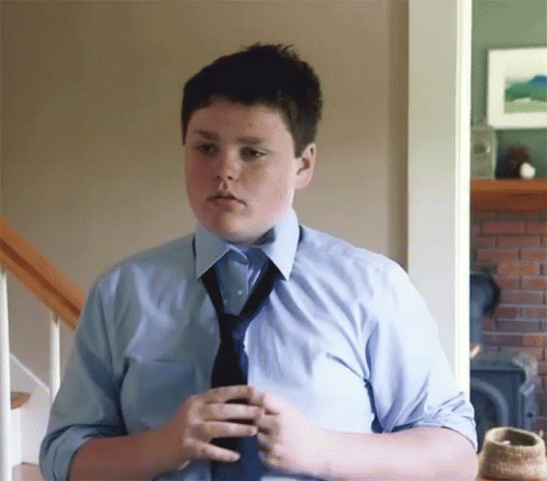 Young Boy in Blue Shirt and Tie