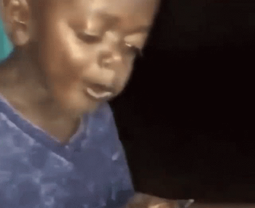 Young Boy in Blue Shirt Eating Food