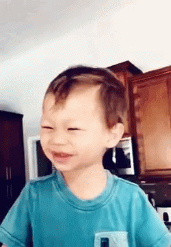 Young Boy in Blue Shirt Making Funny Face