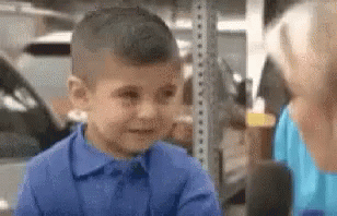 Young Boy in Blue Talking to Woman