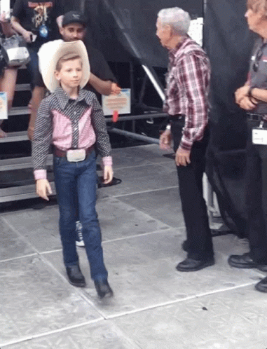 Young Boy in Cowboy Outfit Walking