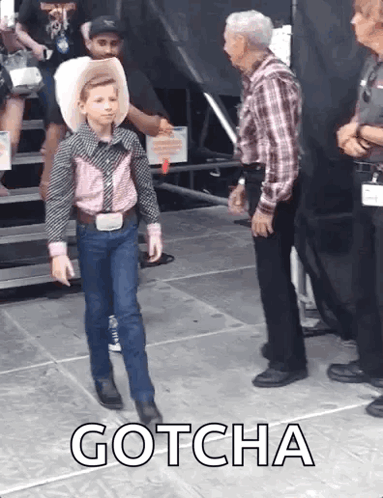 Young Boy In Cowboy Outfit With Older Man And Gotcha Text GIF