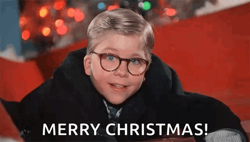 Young Boy in Glasses and Coat Laying on Red Carpet