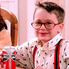 Young Boy In Glasses And Suspenders Holding Pepsi GIF