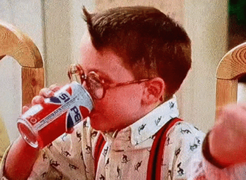 Young Boy in Glasses Drinking Pepsi Can