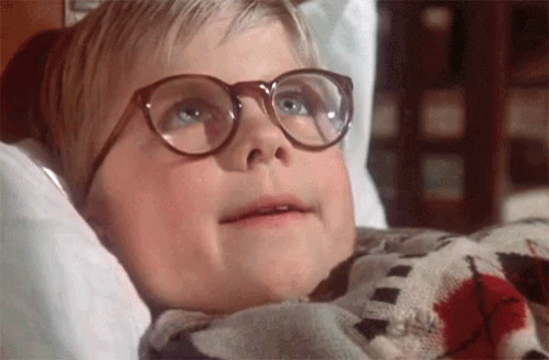 Young Boy in Glasses Lying in Bed With Blanket