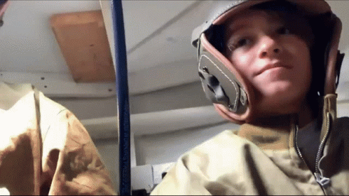 Young Boy In Helmet And Jacket Looking At Camera GIF