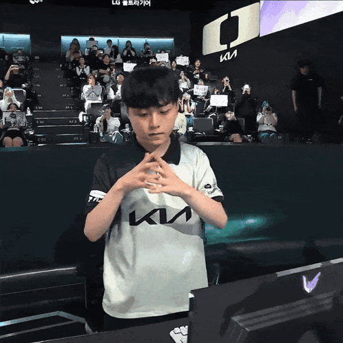 Young Boy in Kia Shirt Before Crowd