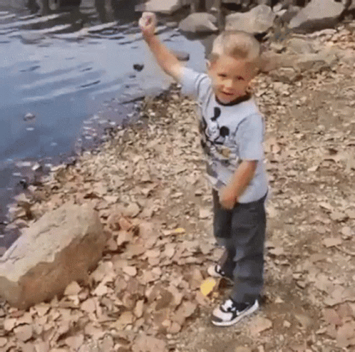 Young Boy in Mickey Mouse Shirt on Shore
