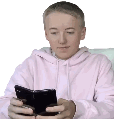 Young Boy in Pink Hoodie Looking at Phone