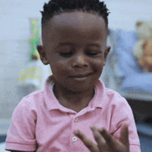 Young Boy in Pink Shirt Clapping
