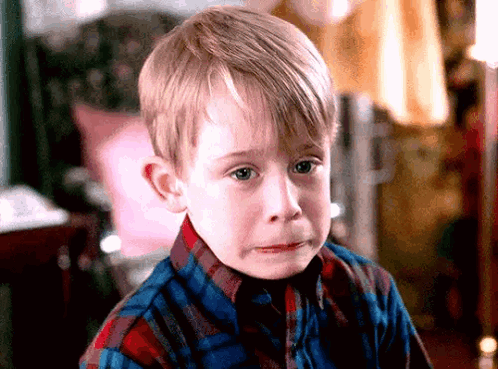 Young Boy in Plaid Shirt Crying