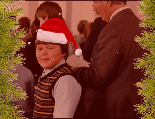 Young Boy in Santa Hat Helped by Man in Suit