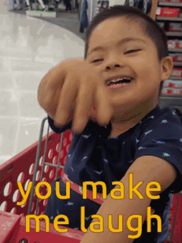 Young Boy In Shopping Cart Saying You Make Me Laugh GIF