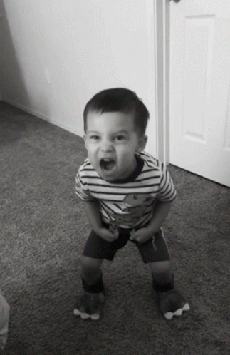 Young Boy In Striped Shirt With Teddy Bear Pumping Fist GIF