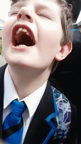 Young Boy in Suit and Tie With Mouth Open